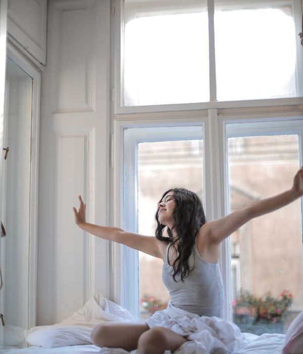 Person doing morning stretching near a window